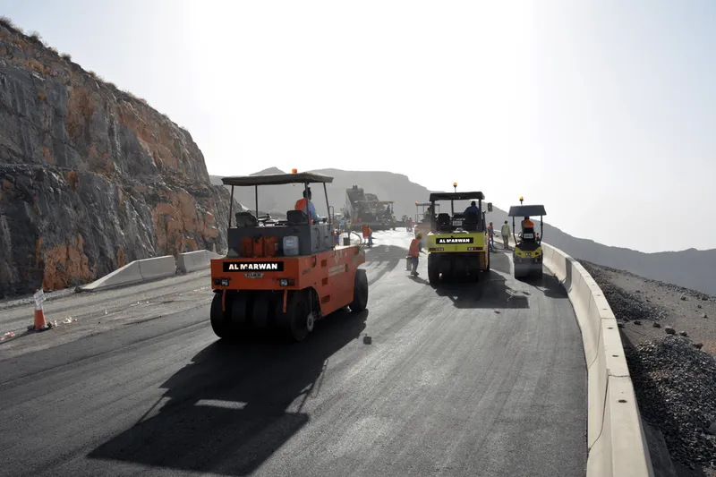 A closeup shot of Al Marwan's equipment rental fleet, notably the Ammann Pneumatic Tire Roller (PTR) at work on Jebel Jais Road