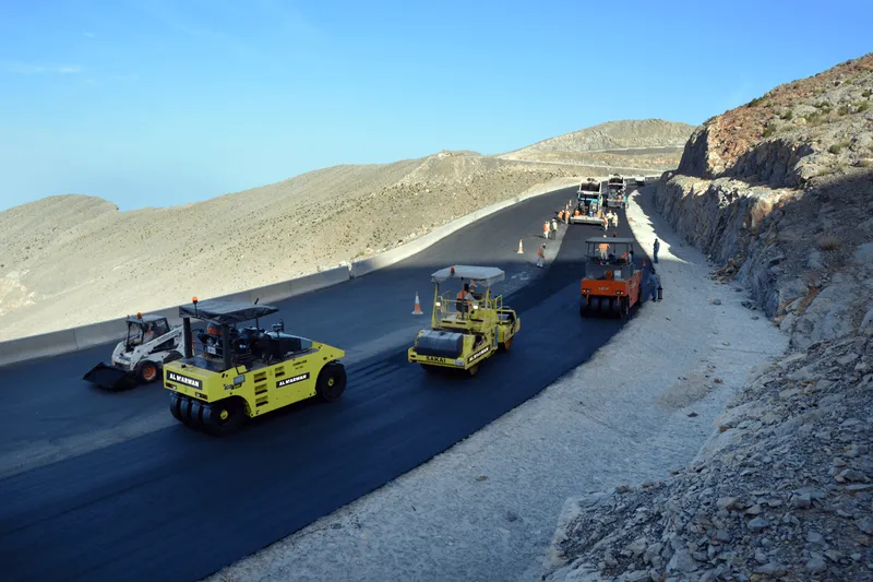 The asphalt and road marking operations conducted by Al Marwan's rental machinery fleet on Jebel Jais Road underway using Sakai and Hamm tandem and double drum rollers