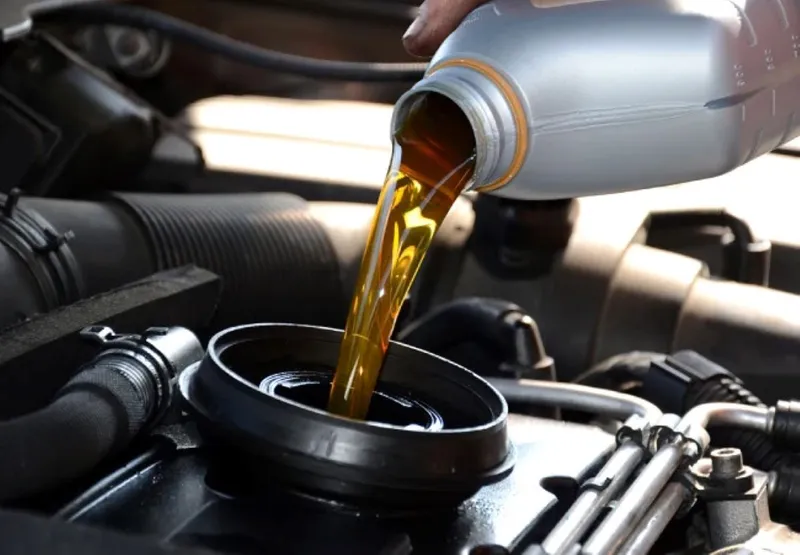 adding hydraulic oil to an excavator
