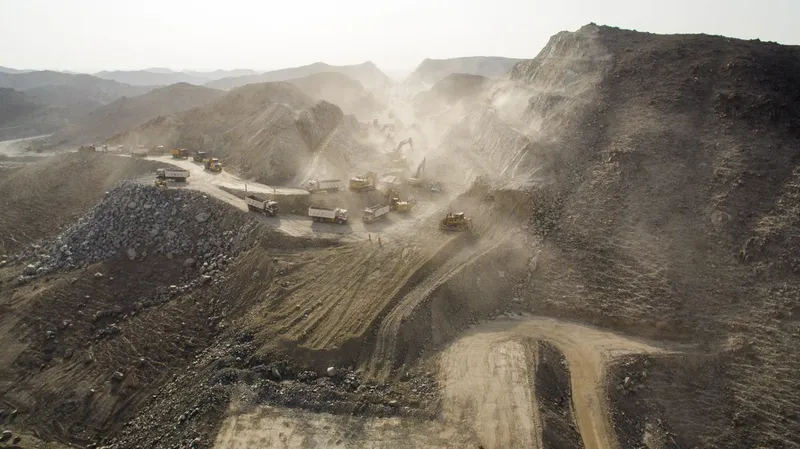 A fleet of trucks and excavators on Al Marwan Machinery's fleet at SHJ-Khor Fakkan Road
