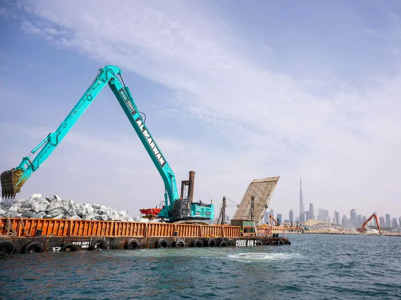 An SK850 Kobelco large excavator equipped with a ROPS on a marine works job site, part of Al Marwan fleet