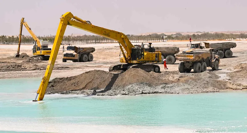 Caterpillar 740 dumpers working seamlessly with long boom excavators on Al Marwan’s BaniYas project