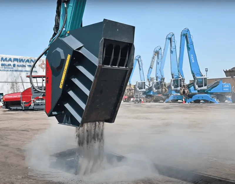 A World Attachments crushing bucket at work, sifting mixed soil