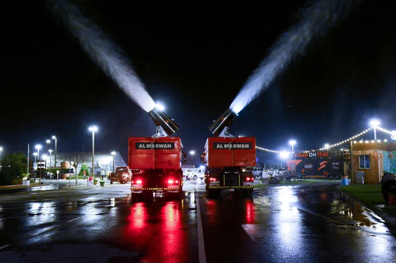 A picture of two of Al Marwan Machinery's water trucks pumping disinfectant in the streets of Dubai in the National Disinfection and Sanitization Program initiated by the Government of Dubai and Dubai Municipality