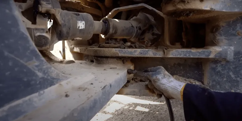 Applying grease to the articulating joint of a wheel loader