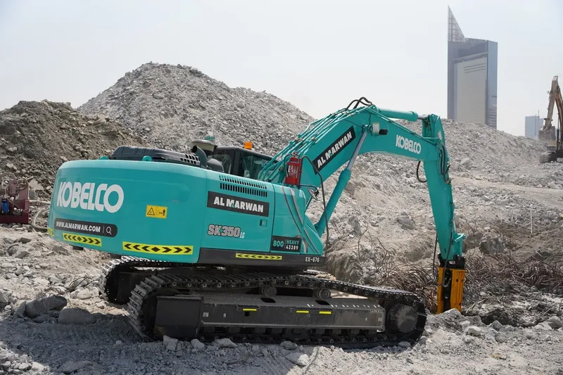 A medium 35-ton KOBELCO SK350 excavator fitted with a Jisung jackhammer