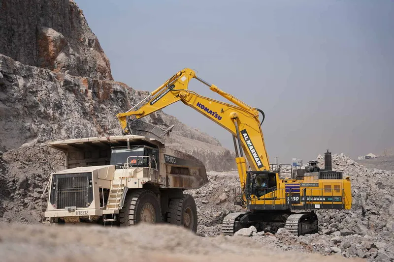 A Komatsu PC1250 working seamlessly with a Terex TR100 hauler.