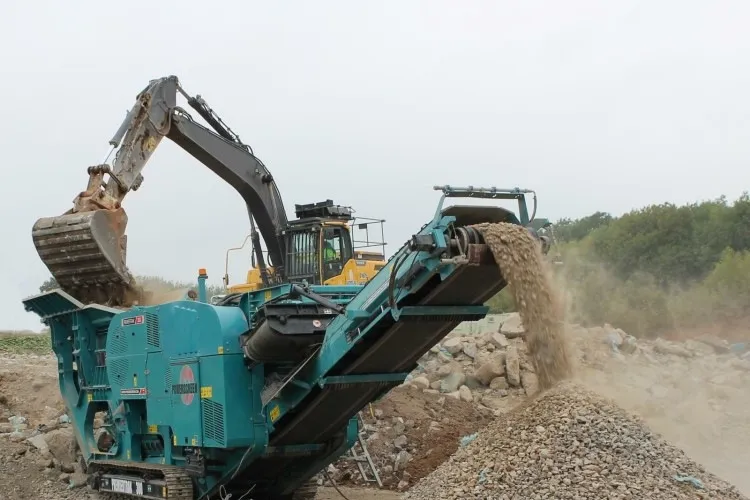 Mobile jaw crushers reduce the size of the rocks.