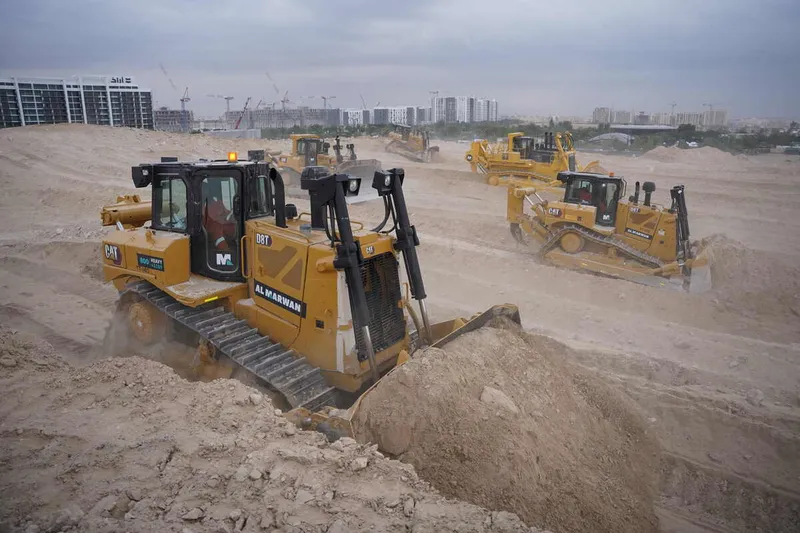 Multiple Al Marwan rental dozers on a job site, including CAT D8T, CAT D9R, Komatsu D475A