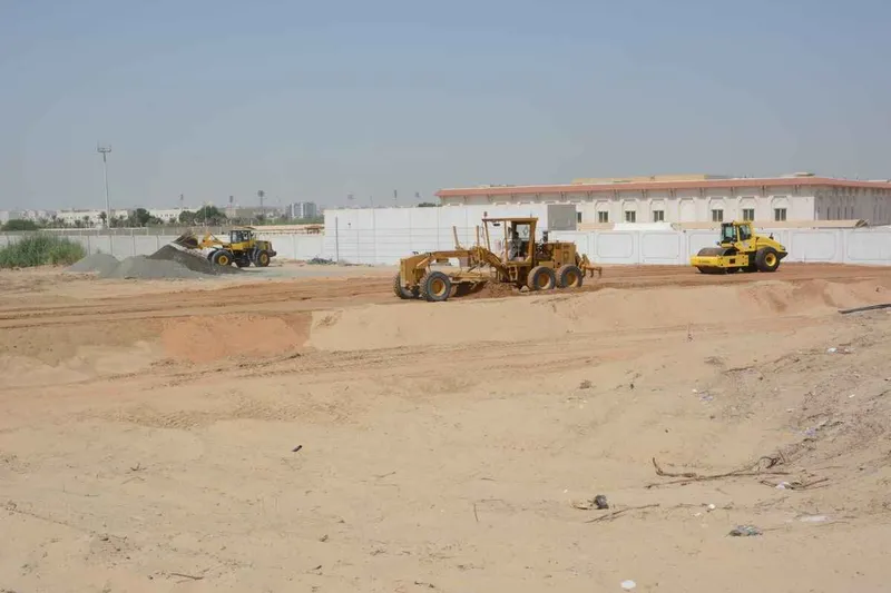A vibratory soil compactor or single drum roller follows the grader as a first phase in compaction