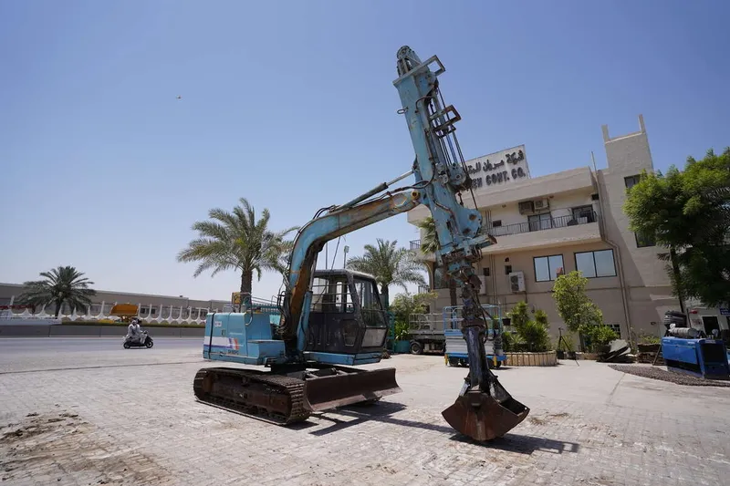 A Sumitomo SH60PC mini excavator attachment fitted with a telescoping boom and grapple for deep ditch excavation