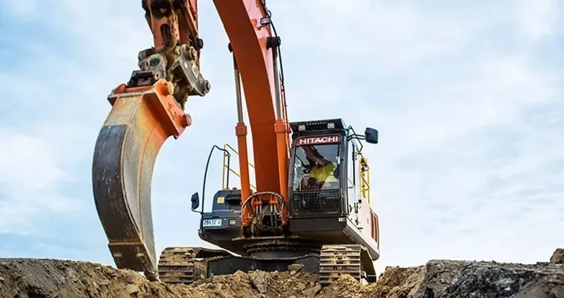 Hitachi excavator attached to a trenching bucket