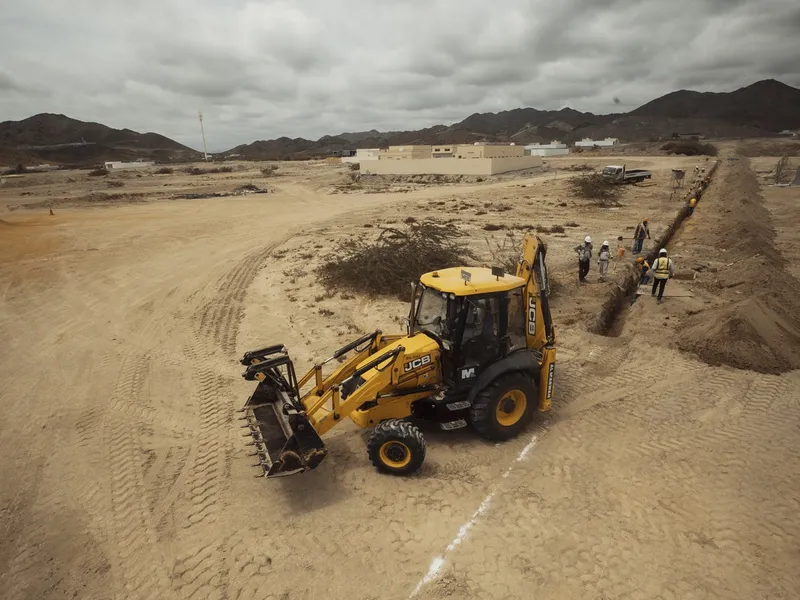The 3CX JCB backhoe's stability is ensured through hydraulic outriggers or stabilizers.