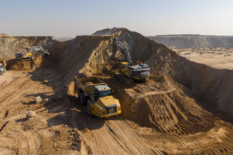 Volvo excavator and Caterpillar articulated dump truck