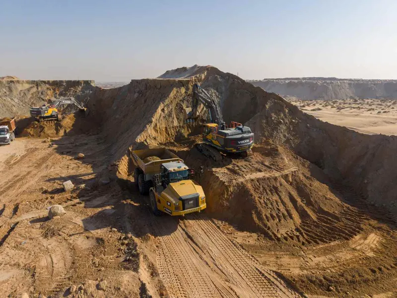 Volvo excavator and Caterpillar articulated dump truck