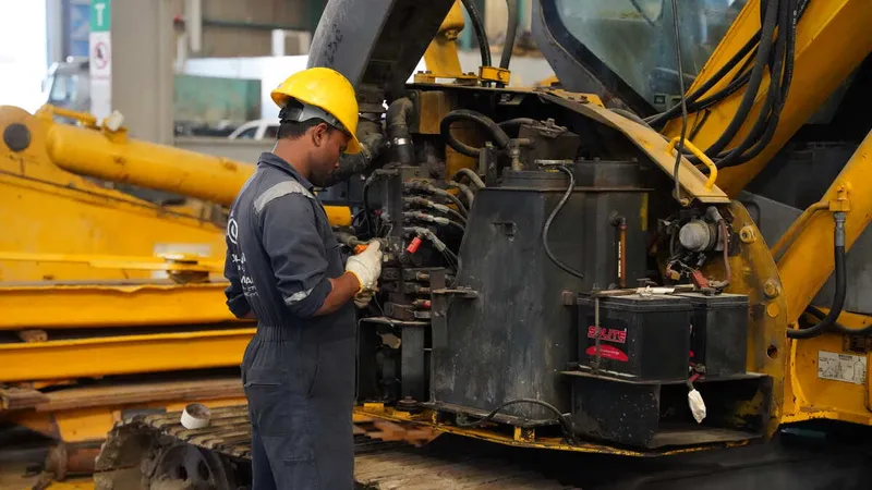 Al Marwan technician working on repairing the excavator 