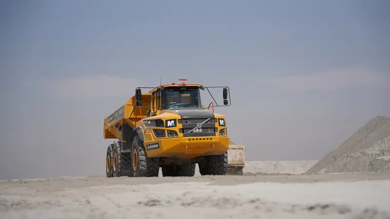 A fleet of Volvo A40G haulers move silt from the sea for on-site aggregate processing in Abu Dhabi, UAE