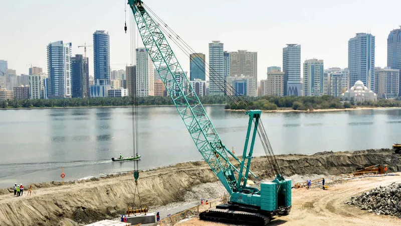 An Al Marwan CKS1350 Kobelco crawler crane on a job site installing prefabricated elements