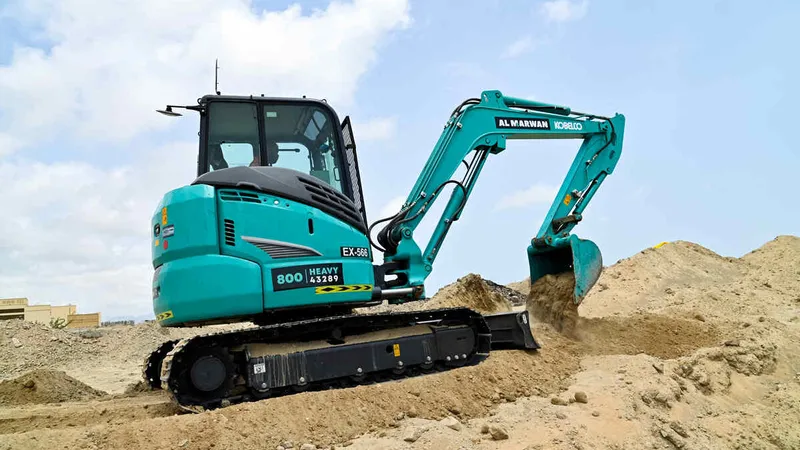 An SK55 Kobelco mini excavator on a UAE job site as part of Al Marwan Machinery fleet