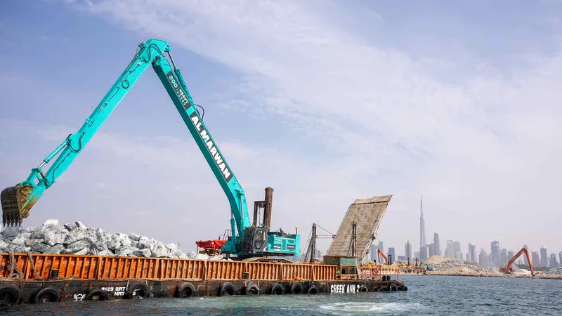 An SK850 Kobelco large excavator equipped with a ROPS on a marine works job site, part of Al Marwan fleet