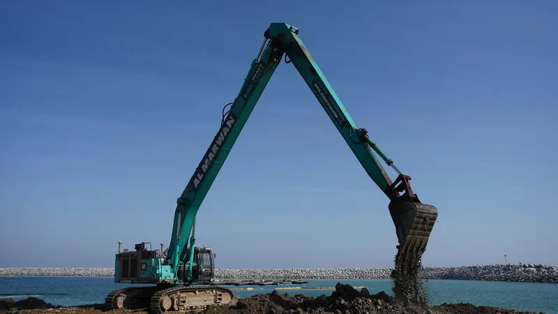 An SK500 Kobelco excavator on a job site as part of Al Marwan Machinery rental fleet