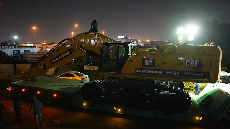 The large CAT 395 long-reach excavator being mobilized to the movie set in Abu Dhabi