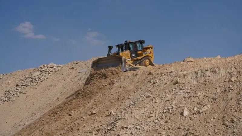 CAT D8T bulldozer at work on a desert construction site in Abu Dhabi, UAE as part of Al Marwan Heavy Machinery equipment rental fleet