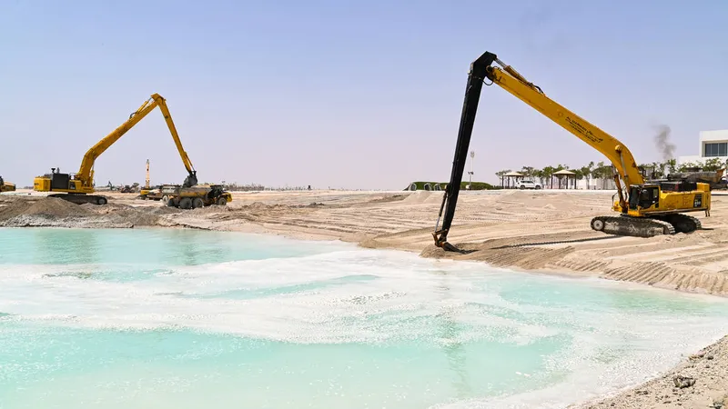 long-reach boom excavators at work on a construction site - Al Marwan Machinery