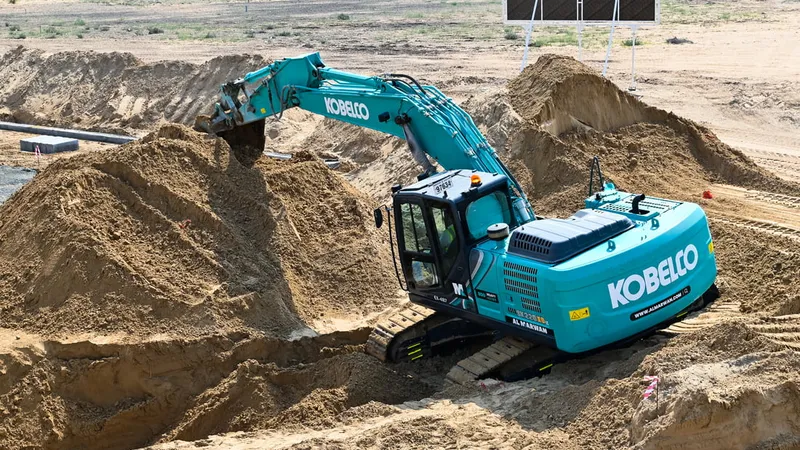 A picture showcasing the robust Kobelco excavator being used in the desert