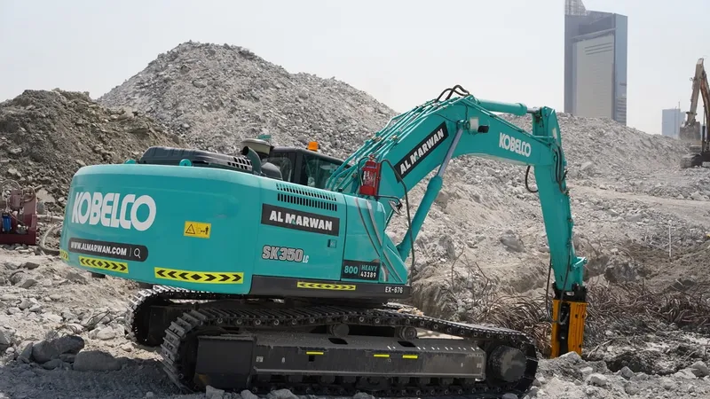 A medium 35-ton KOBELCO SK350 excavator fitted with a Jisung jackhammer