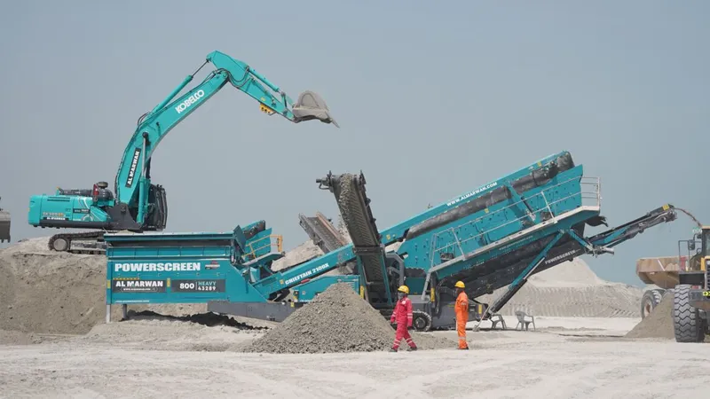 An excavator and a screener on a job site, from Al Marwan, the region's authorized distributor for brand-new Kobelco and Powerscreen equipment