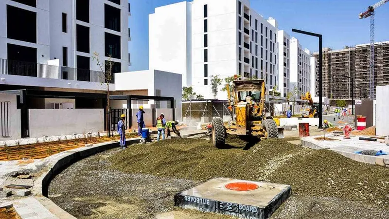 The Komatsu GD755-5R motor grader grading around residential real estate at Al Jada by Arada development project