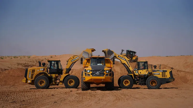 Komatsu WA470 & CAT 966L rented loaders working alongside a Volvo A40G dump truck from Al MArwan's rental fleet