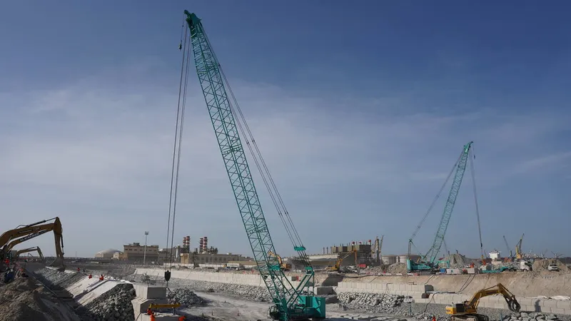 Multiple Al Marwan Kobelco crawler cranes on a UAE job site