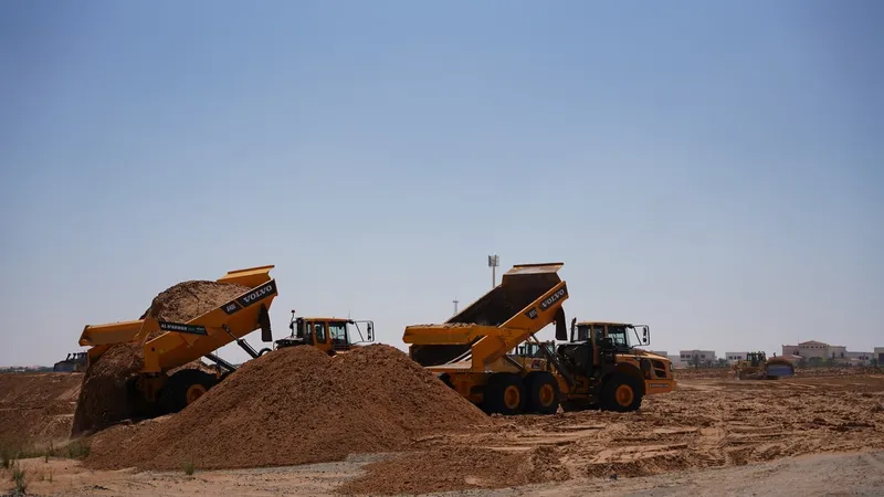 A couple of Volvo A40G's on a construction site in the desert