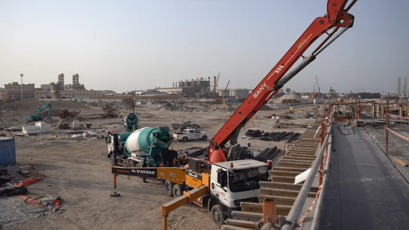 A concrete pump truck laying fresh material into a newly constructed building