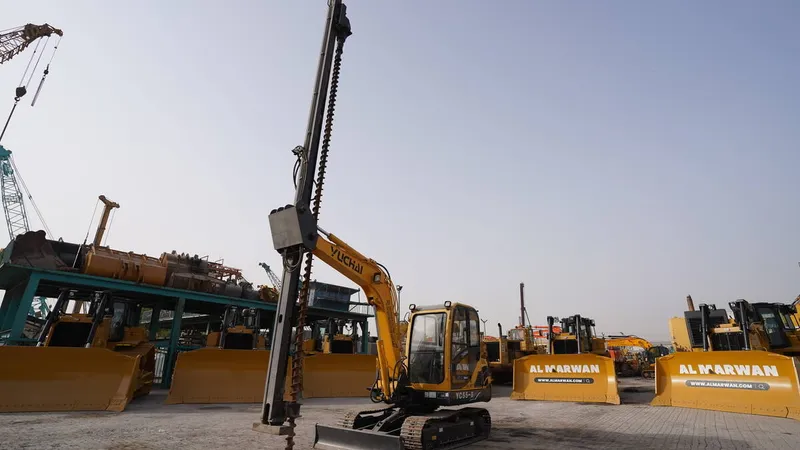 A Yuchai YC55-8 mini excavator attachment equipped with an auger for post drilling
