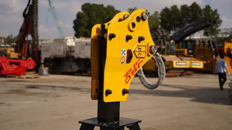 Jisung (JSC) 20GT BL jackhammer used as a machinery attachment for a backhoe loader