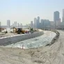 A picture of various road building equipment such as the JCB 3CX backhoe loader excavating and laying foundations for the connecting road between Al Majaz Island and the waterfront