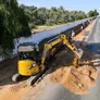 A CAT mini excavator at work on a rental equipment for landscaping project in Sharjah, UAE