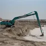 A Kobelco SK500 excavator equipped with a long boom, part of the Al Marwan machinery fleet
