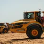 Two Volvo A40G dump trucks in action.