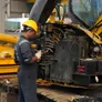 Al Marwan technician working on repairing the excavator 