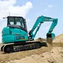 An SK55 Kobelco mini excavator on a UAE job site as part of Al Marwan Machinery fleet