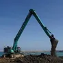 An SK500 Kobelco excavator on a job site as part of Al Marwan Machinery rental fleet