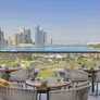 A picture showcasing the panoramic outdoor view of Al Majaz Waterfront and Khalid Lagoon offered by the cozy atmosphere of Majdolin restaurant in the DoubleTree by Hilton Hotel Sharjah