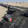 A picture of the asphalt team finishing the roadways at Tilal City using tipper trucks, pavers, rollers, and skid loaders
