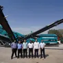 A picture documenting the visit of Powerscreen's regional sales office manager to Al Marwan's HQ standing in front of the Chieftain 2100X screener