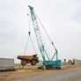 A KOBELCO CKS1350 lifting a large CAT haul truck