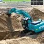 A picture showcasing the robust Kobelco excavator being used in the desert
